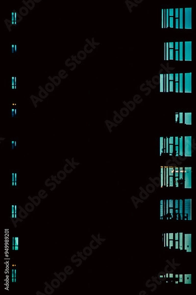 Obraz Silhouette of an office building with a blue evening sky shining through the windows