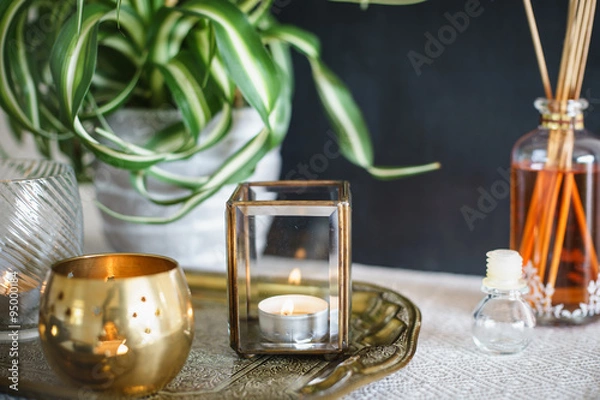 Obraz Vintage home decor: candles, aroma diffuser, plant and frames. Selective focus