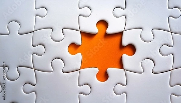 Fototapeta Picture of an orange puzzle piece that fits into a white puzzle. Teamwork, solutions, and problem-solving concepts are emphasized.