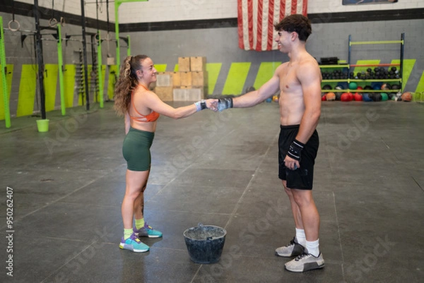 Obraz Man and woman shaking hands in gym after workout