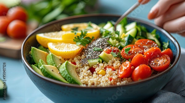 Fototapeta Colorful quinoa salad featuring creamy avocado, juicy cherry tomatoes, crunchy cucumber, topped with chia seeds and zesty lemon vinaigrette, perfect for a healthy meal.