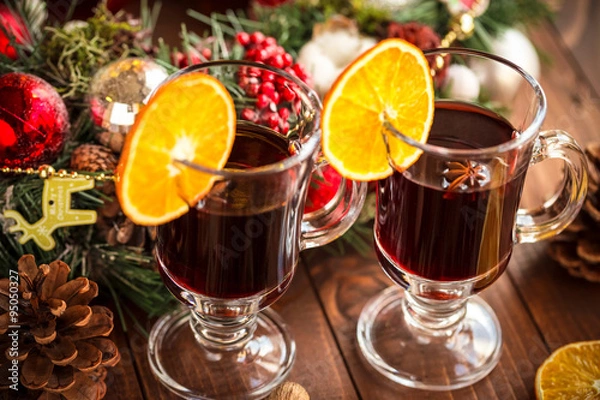 Fototapeta Christmas hot mulled wine with spices on a wooden table. The idea for creating greeting cards