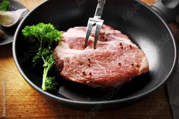 Fototapeta Marbled beef steak on pan and spices on wooden background