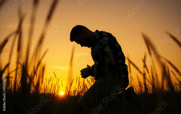 Obraz Prayer concept. Silhouette of a man in a praying pose. On his Knees forgiveness. vibrant sunset sunrise sky. Clasped hands lonely. sacrifice, sincerity , sanctification, shepherd, trinity, shadow