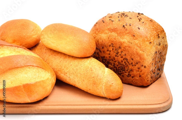 Obraz Bread on cutting board isolated on white