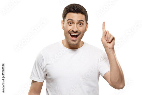 Fototapeta Young man in white t-shirt pointing up with his finger feeling excited with open mouth, showing benefit of commercial offer