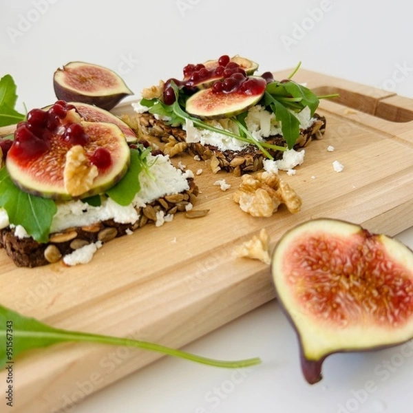 Fototapeta Toast with Figs, Cheese and Arugula on Bread Slice Photo
