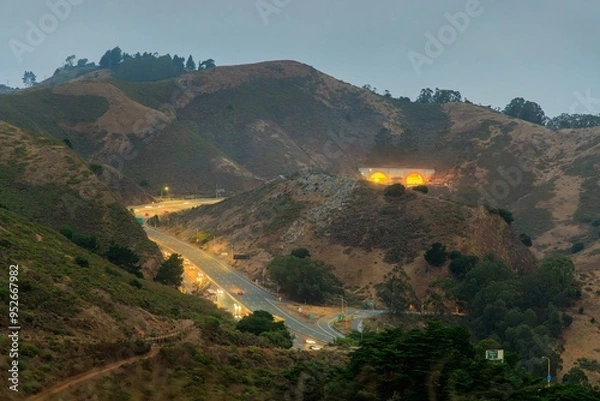 Fototapeta Light traffic on highway through try Marin County hills approaching tunnel