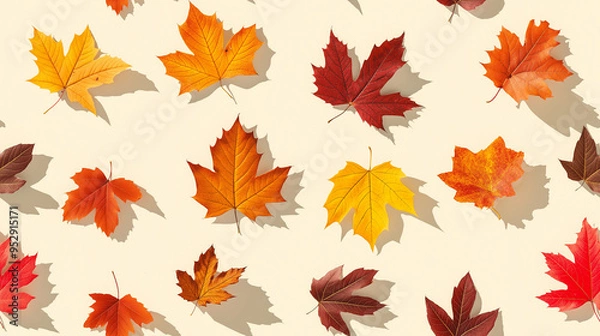 Fototapeta colorful autumn leaves in shades of red, orange, and yellow, each with a shadow, randomly placed on a soft cream background