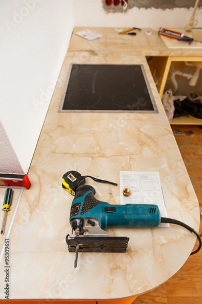 Fototapeta Installing new hob in modern kitchen