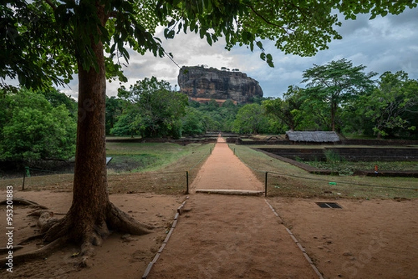 Fototapeta SIGIRIYA, SRI LANKA - JULY 15, 2024 : A view looking through the Royal Garden towards Sigiriya Rock Fortress in central Sri Lanka.