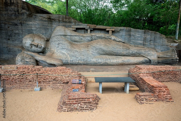 Fototapeta The reclining Buddha statue of Gal Vihara at the ancient site of Polonnaruwa in Sri Lanka. It is carved out of a single slab of granite rock.