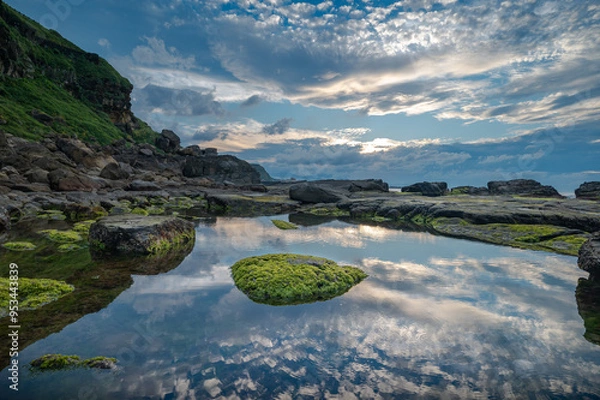 Obraz Sunset time in the coastline of Keelung city, ocean reflect the sky and cloud, rocks full of seaweed, in Taiwan.