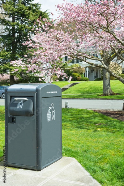 Fototapeta Waste Management Solar Powered Trash Compactor in Park