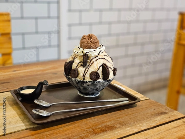Fototapeta Chocolate bingsu is shaved ice with chocolate sauce, topped with chocolate chips, cookies, and chocolate ice cream.