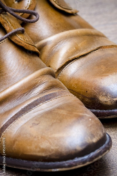 Obraz Brown leather shoes on a wooden floor 