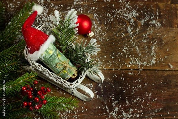 Obraz Gift money with red ribbon and Santa cap