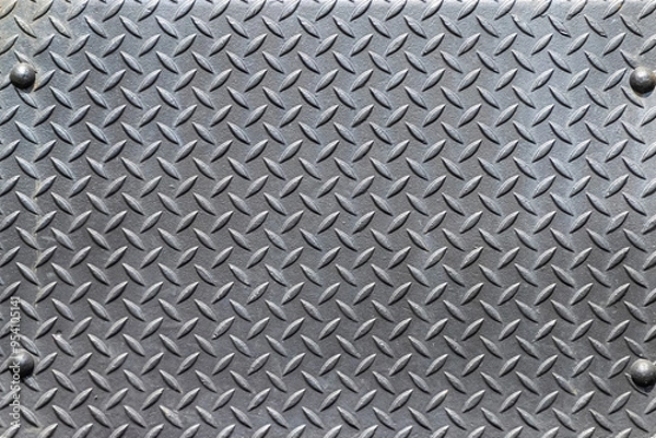 Fototapeta Closeup of a riveted with button-head rivets steel checkered plate as an industrial background