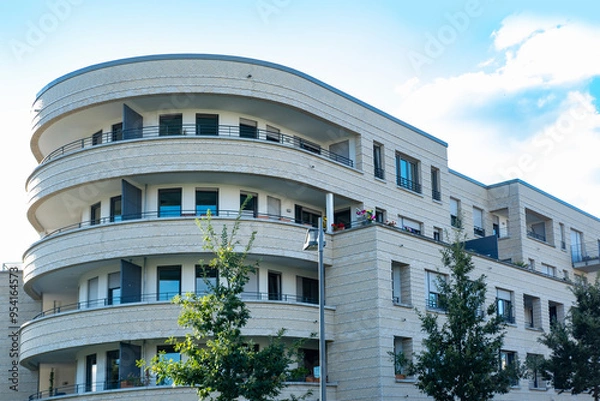 Fototapeta Contemporary residential buildings, community with lush greenery, modern architecture and well-maintained landscape, New apartment buildings
