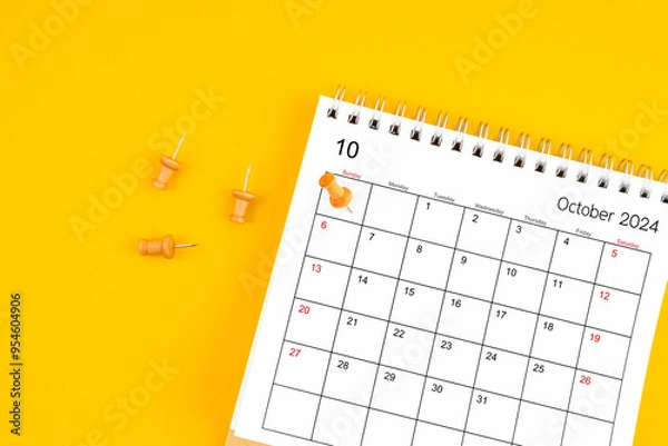 Fototapeta October 2024 Monthly desk calendar for 2024 year with wooden pin on yellow background.