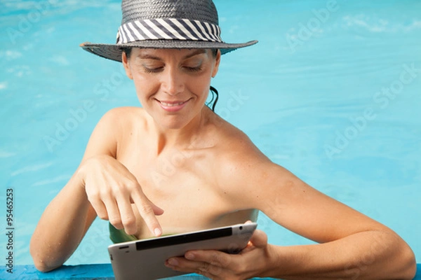 Fototapeta Pretty woman relaxed and point something in ipad