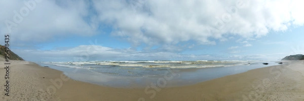 Fototapeta Der Strand von ..., mit Wolken und Wellen
