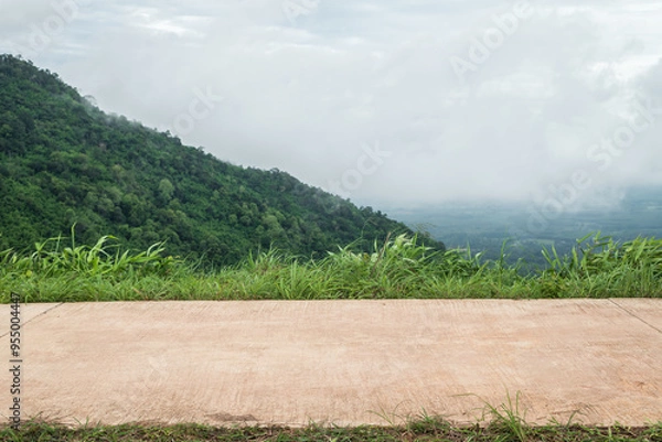 Fototapeta Side view of concrete road with meadow