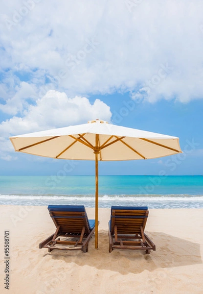 Fototapeta Beach chairs with umbrella and beach on a sunny day