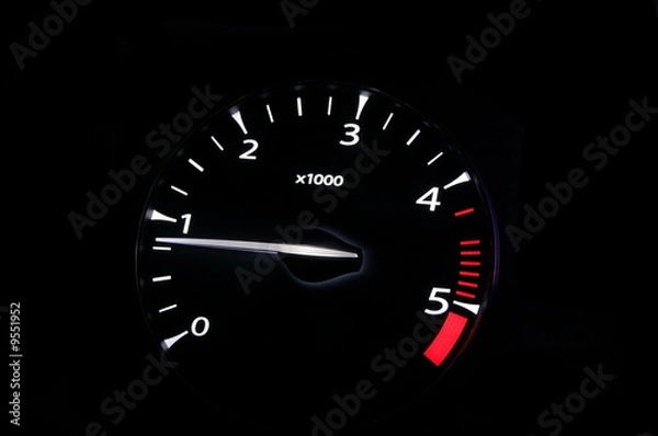 Fototapeta moving revs meter of a sports car on a black background.