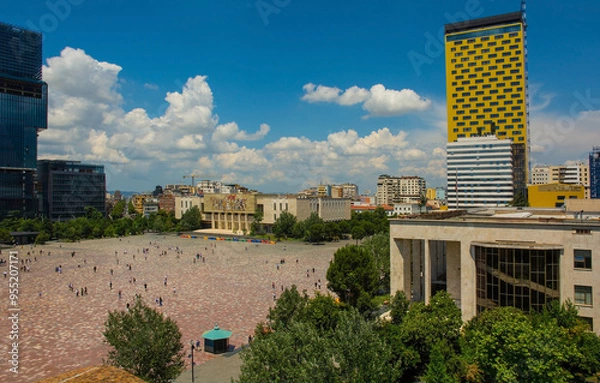 Fototapeta Skanderbeg Square in Tirana,Albania,viewed from the top of Clock Tower over the roof of Ethem Bey Mosque.Centre-National History Museum with the iconic Albanians mosaic. Left-Eyes of Tirana skyscraper