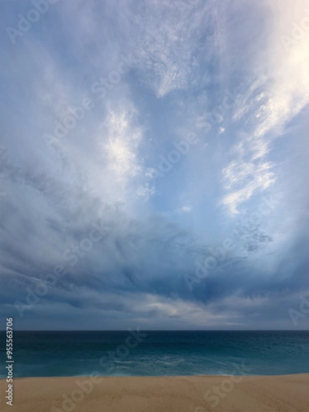 Fototapeta Dim moody beach at the Pacific ocean on a overcast stormy day