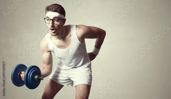 Obraz young nerd try to lift weights