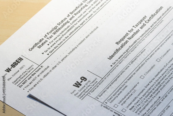 Obraz Closeup of Form W-9, Request for Taxpayer Identification Number (TIN) and Certification, and Form W-8 BEN, Certificate of Foreign Status of Beneficial Owner for U.S. Tax Withholding and Reporting.