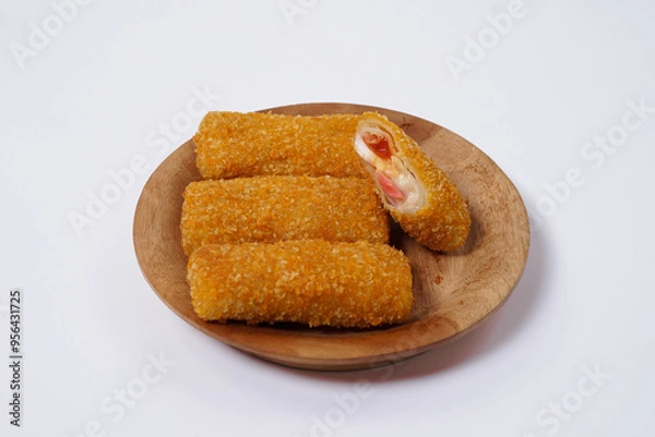 Fototapeta American Risoles or risoles mayo is a traditional Indonesian snack filled with smoked beef or sausage, boiled eggs & mayonnaise. Crispy texture on the outside. Risoles on wood plate isolated white.
