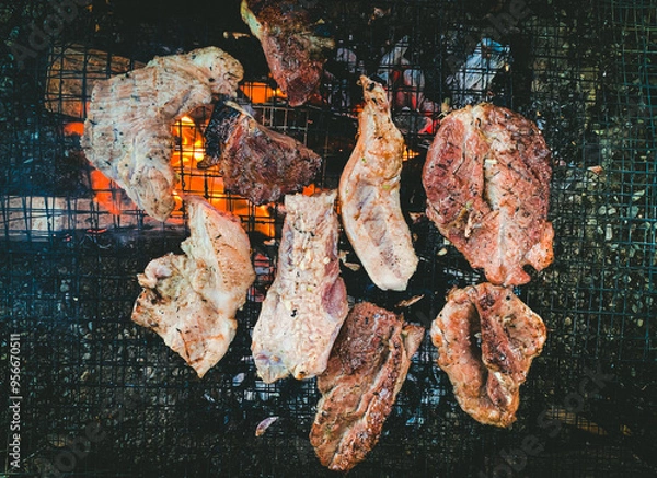Obraz Grilled Meat on Barbecue, Closeup of Juicy Steaks and Pork Cooking Over Open Fire, High-Quality BBQ Stock Image for Food Photography and Culinary Concepts.