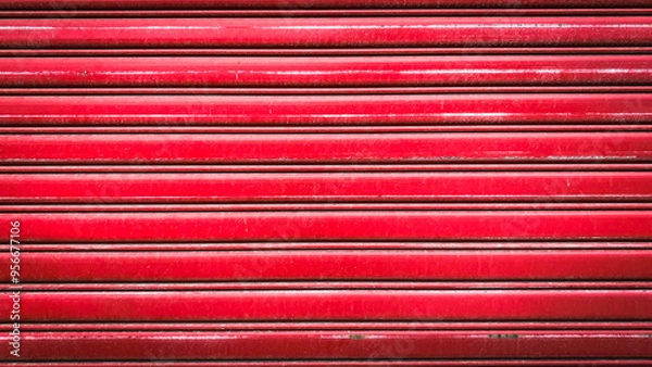Obraz A vibrant red metal rolling door showcasing durability and strength, perfect for industrial and commercial environments. This image represents protection.