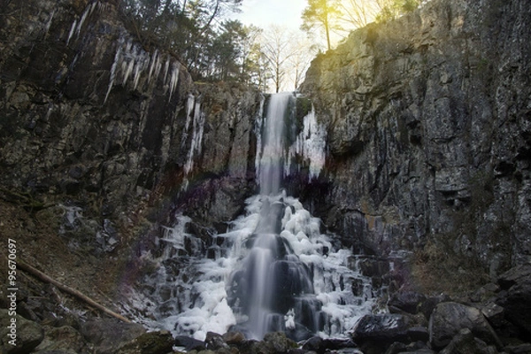 Fototapeta Waterfall on a mountain in the forest