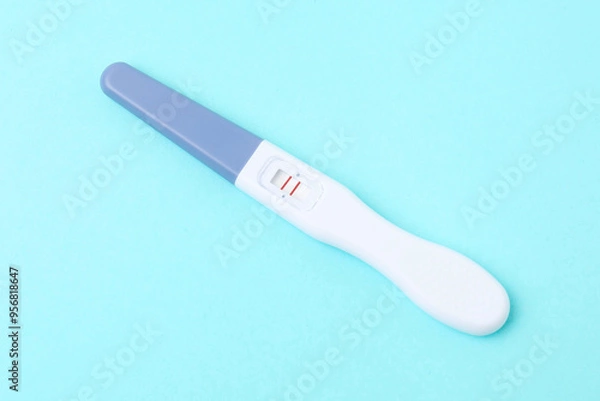 Obraz One pregnancy test on light blue background, closeup
