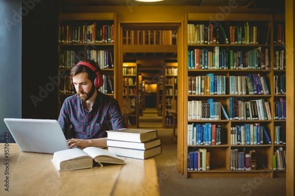 Fototapeta Hipster student studying in library