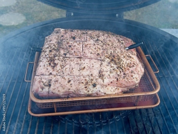 Obraz Pork shoulder smoked on a charcoal grill for pulled pork