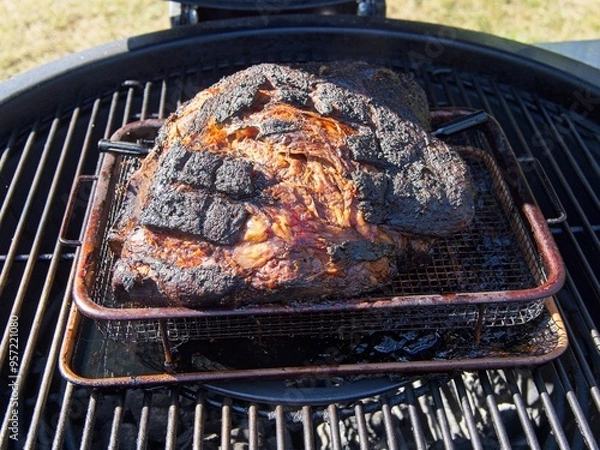 Obraz Pork shoulder smoked on a charcoal grill for pulled pork