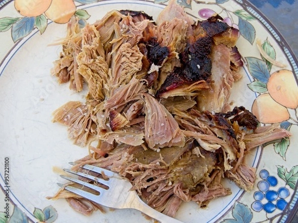 Obraz Pork shoulder smoked on a charcoal grill for pulled pork