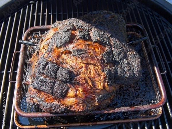 Obraz Pork shoulder smoked on a charcoal grill for pulled pork