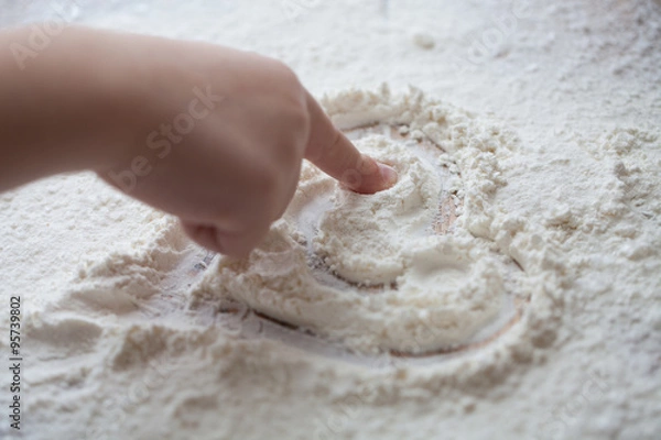 Fototapeta Heart of flour on wooden desk painted by a child