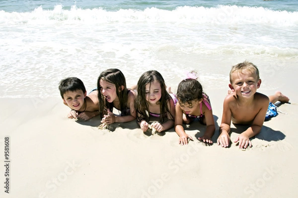 Fototapeta 5 Children laying on the sand