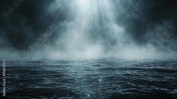 Fototapeta A beam of light shines through a dense fog over a dark, rippling body of water.