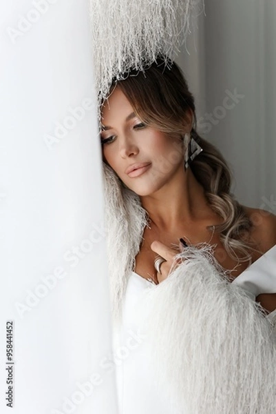 Obraz Professional studio portrait of a well-groomed brunette in white. Feminine, beautiful middle age.