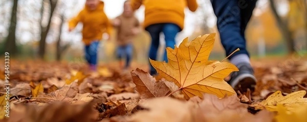 Obraz Children playing in a vibrant autumn landscape, surrounded by colorful leaves, capturing the joy of fall in a park setting.