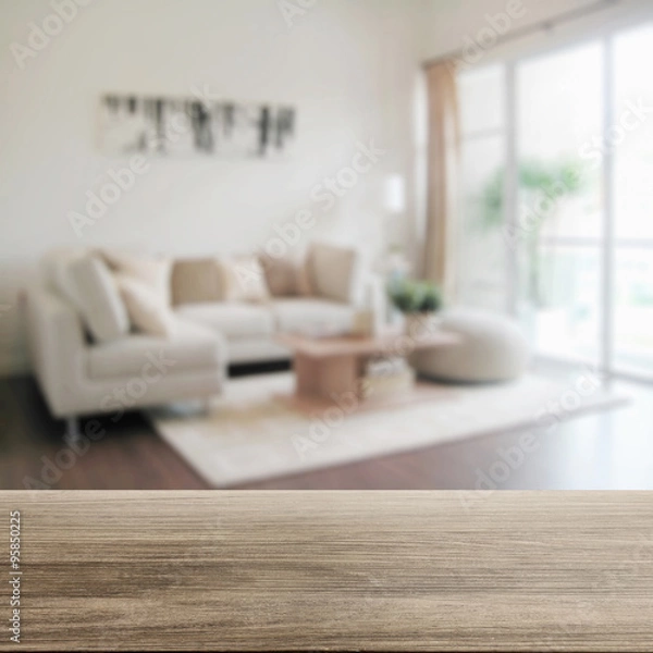 Fototapeta wooden table top with blur of modern living room interior