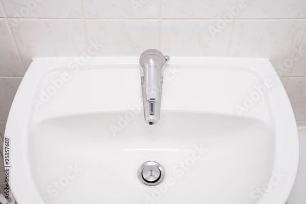 Obraz Clean sink and chrome faucet in a bathroom